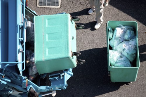 Waste being loaded into an enclosed skip